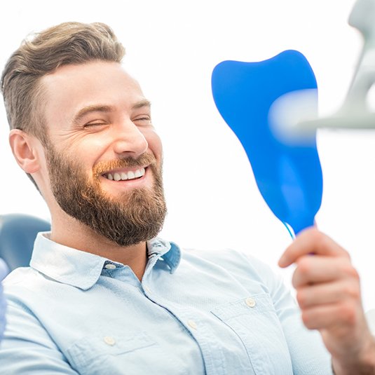 A man smiling at the dentist