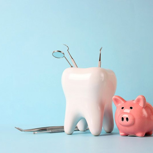 a tooth next to a piggy bank