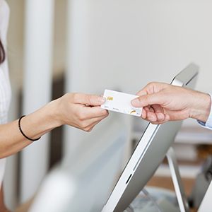 Dental receptionist accepting credit card
