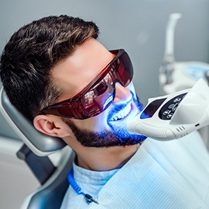 Man in dental chair having teeth whitened